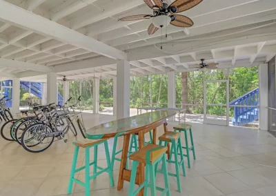 Flamingo Harbor screened patio area with bicycles, table and chairs