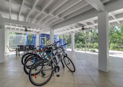 Flamingo Harbor screened in patio with table and chairs and bicycles
