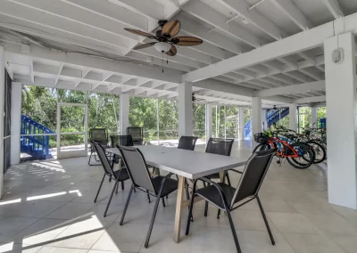 Flamingo Harbor screened in patio with table and chairs and bicycles
