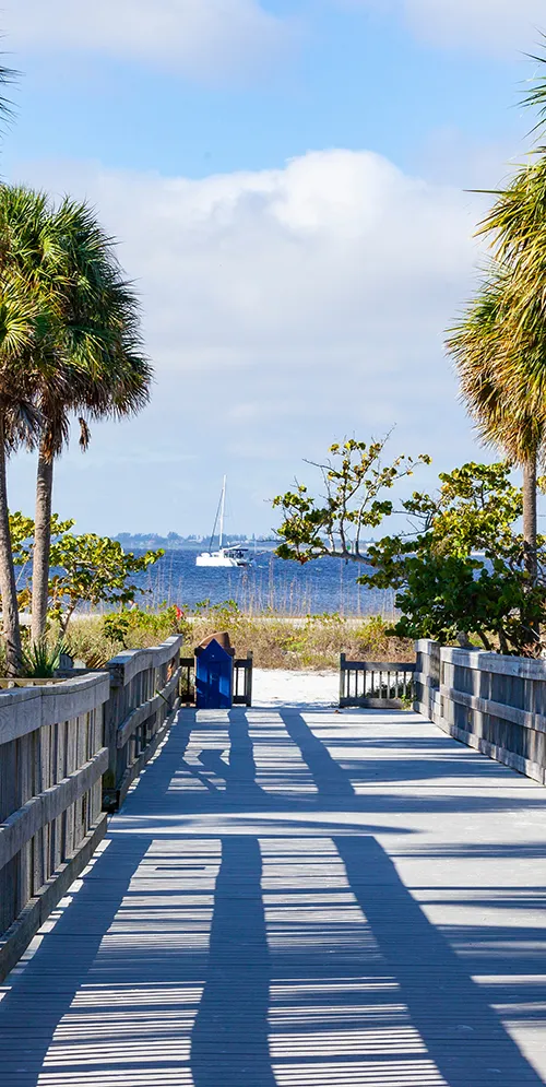 Ft. Myers Beach path to water with sailboat